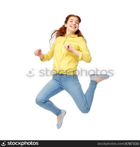 happiness, freedom, motion and people concept - smiling young woman jumping in air