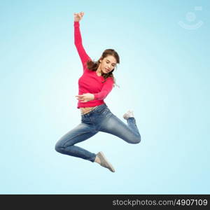 happiness, freedom, motion and people concept - smiling young woman jumping in air over blue background. smiling young woman jumping in air