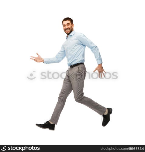 happiness, freedom, movement and people concept - smiling young man jumping in air