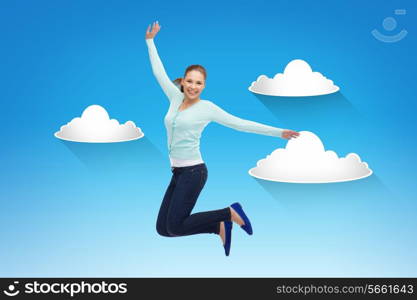 happiness, freedom, movement and people concept - smiling young woman jumping in air over blue sky with white clouds background