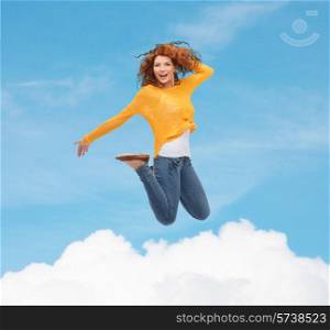 happiness, freedom, movement and people concept - smiling young woman jumping in air over blue sky with white cloud background