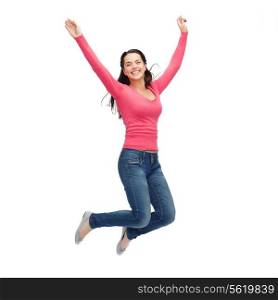 happiness, freedom, movement and people concept - smiling young woman jumping in air