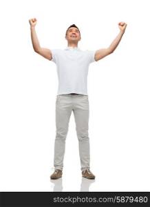 happiness, gesture and people concept - happy man with raised hands