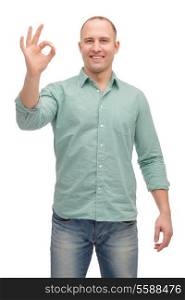 happiness, gesture and people concept - smiling man showing ok-sign