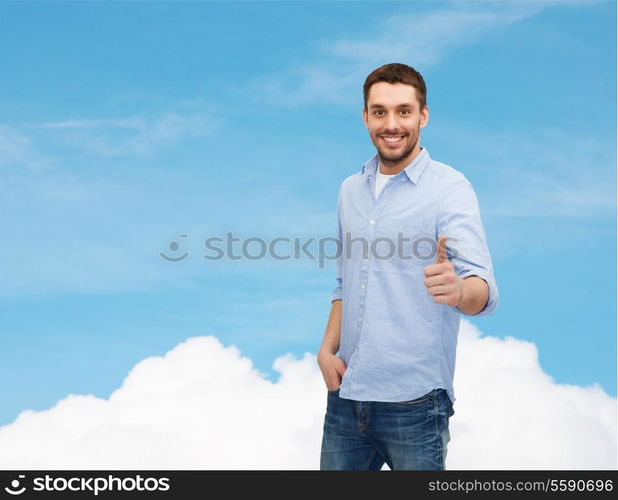 happiness, gesture and people concept - smiling man showing thumbs up