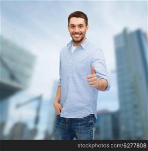 happiness, gesture and people concept - smiling man showing thumbs up