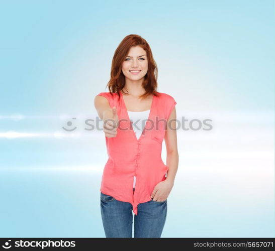 happiness, gesture and people concept - smiling teenage girl in casual clothes showing thumbs up over blue laser background