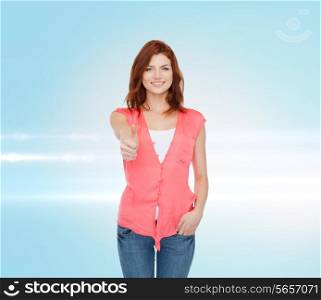 happiness, gesture and people concept - smiling teenage girl in casual clothes showing thumbs up over blue laser background