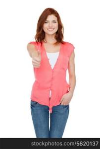 happiness, gesture and people concept - smiling teenage girl in casual clothes showing thumbs up