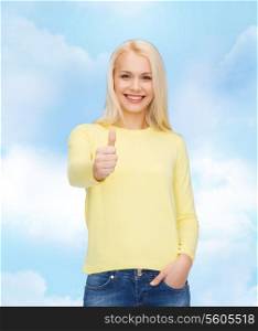 happiness, gesture and people concept - smiling young woman in casual clothes showing thumbs up