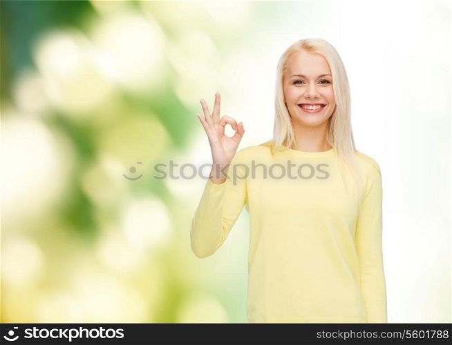happiness, gesture and people concept - young businesswoman showing ok sign
