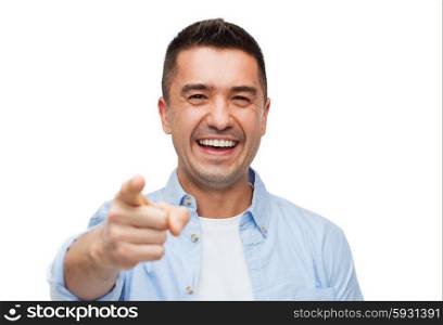 happiness, gesture, emotions and people concept - smiling man pointing finger on you