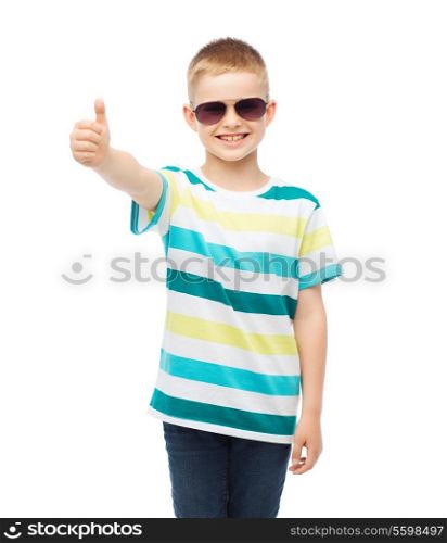 happiness,gesture, summer and people concept - smiling cute little boy in sunglasses showing thumbs up