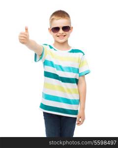 happiness,gesture, summer and people concept - smiling cute little boy in sunglasses showing thumbs up