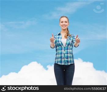 happiness, gesutre and people concept - smiling young woman in casual clothes showing thumbs up over blue sky background