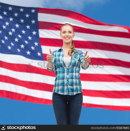 happiness, gesutre and people concept - smiling young woman in casual clothes showing thumbs up