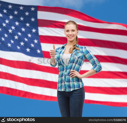 happiness, gesutre and people concept - smiling young woman in casual clothes showing thumbs up