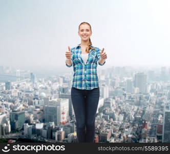 happiness, gesutre and people concept - smiling young woman in casual clothes showing thumbs up