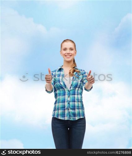 happiness, gesutre and people concept - smiling young woman in casual clothes showing thumbs up