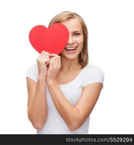 happiness, health and love concept - smiling woman in white t-shirt with covering half face with heart