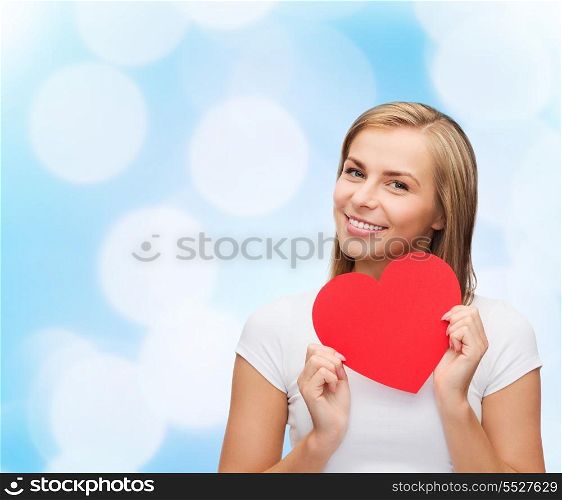 happiness, health and love concept - smiling woman in white t-shirt with heart