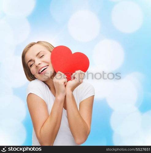 happiness, health and love concept - smiling woman in white t-shirt with heart