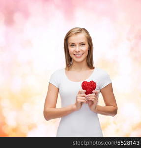 happiness, health and love concept - smiling woman in white t-shirt with heart