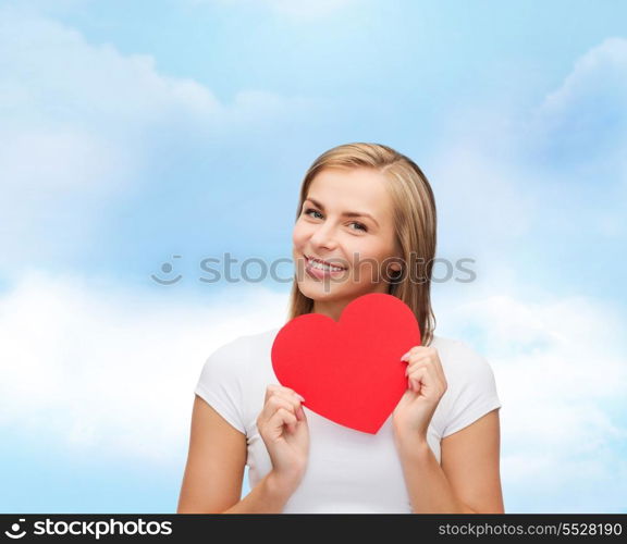 happiness, health and love concept - smiling woman in white t-shirt with heart