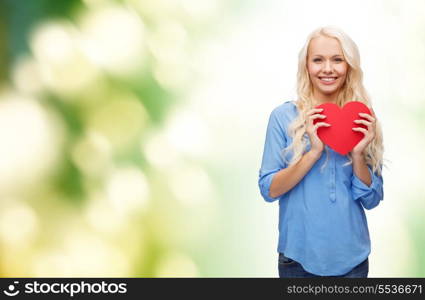 happiness, health and love concept - smiling woman with red heart