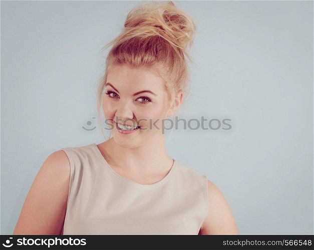 Happiness human face expressions concept. Happy positive cheerful smiling woman with blonde hair tied in bow. Happy positive smiling blonde woman