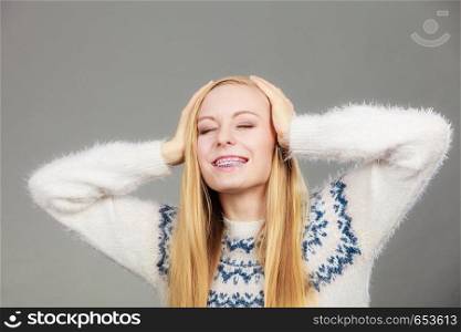 Happiness, human reactions, face expressions concept. Happy blonde woman holding head out of joy. Happy blonde woman holding head out of joy