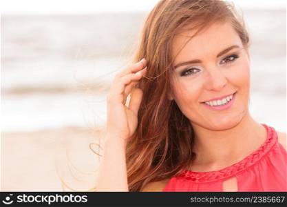 Happiness in summer time. Beauty smiling gorgeous girl with long hair blowing on wind. Attractive and fashion woman on beach.. Gorgeous attractive young woman in summer.