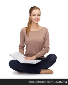 happiness, leisure and people concept - smiling young woman sitting on floor and reading book