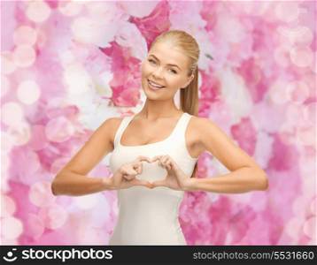 happiness, love and medicine concept -woman showing heart shape gesture