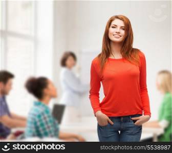happiness, school, education and people concept - smiling teenager in casual top and jeans at school