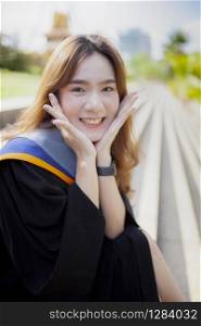 happiness smiling face of asian younger woman wearing university gruation suit