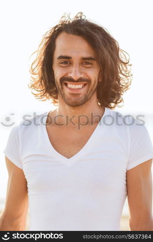 happiness, summer, advertising and people concept - smiling man in white blank shirt outdoors