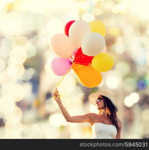 happiness, summer, holidays and people concept - smiling young woman wearing sunglasses with balloons over lights background