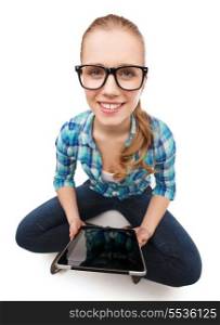 happiness, technology, internet and people concept - smiling young woman in casual clothes sitiing on floor with tablet pc computer