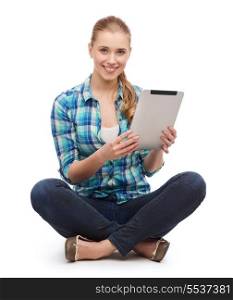 happiness, technology, internet and people concept - smiling young woman in casual clothes sitiing on floor with tablet pc computer