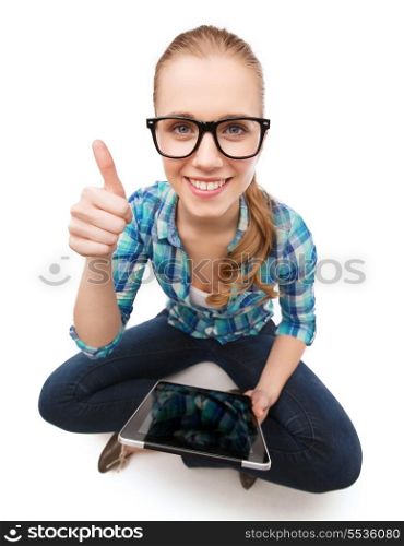 happiness, technology, internet and people concept - smiling young woman sitiing on floor with tablet pc and showing thumbs up