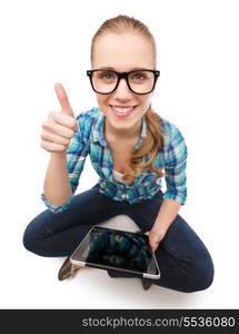 happiness, technology, internet and people concept - smiling young woman sitiing on floor with tablet pc and showing thumbs up