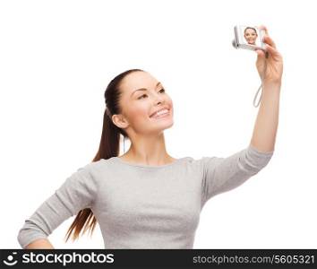 happiness, technology people concept - smiling asian woman taking photo with digital camera