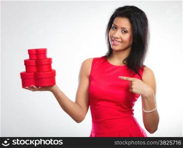 Happiness, valentines day and love concept. Attractive elegant woman in red dress, girl mixed race holding red heart-shaped gift boxes on gray