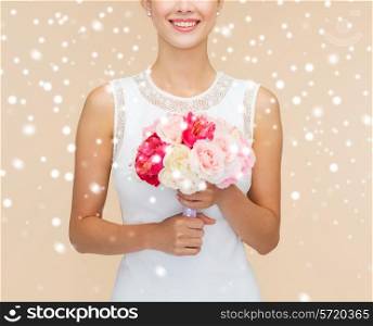 happiness, wedding, holidays and celebration concept - close up of smiling bride or bridesmaid in white dress with bouquet of flowers over beige background and snow