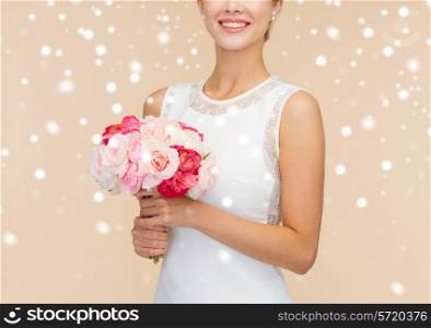 happiness, wedding, holidays and celebration concept - close up of smiling bride or bridesmaid in white dress with bouquet of flowers over beige background and snow