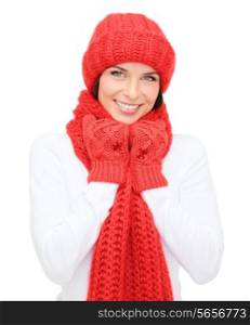 happiness, winter holidays, christmas and people concept - smiling young woman in red hat, scarf and mittens over white background
