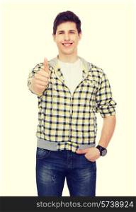 happiness, youth and people concept - smiling student boy showing thumbs up gesture