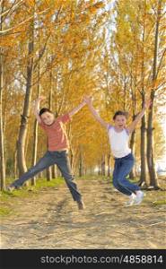 Happy active children jumping in forest
