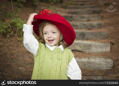 Happy Adorable Child Girl with Red Hat Playing Outside.